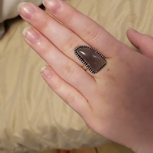 Silver ring with purple gem